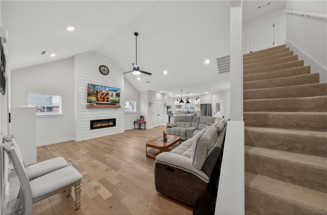 Welcome to your new oasis. Sitting on a west-facing corner lot with a fully stained privacy-fenced yard, this spectacular home checks all your boxes. The open-concept main level is great for entertaining, featuring vaulted ceilings, beautiful flooring throughout, custom cabinetry, granite countertops, and a stylish backsplash. The primary suite and guest quarters with a full-size bathroom is located on the main floor. Upstairs offers two more bedrooms, a full bath, and a bonus second living area. The oversized two-car garage is finished with epoxy flooring, and professional front yard landscaping adds serious curb appeal. This home is absolutely stunning with so much to offer. Schedule your private tour today.