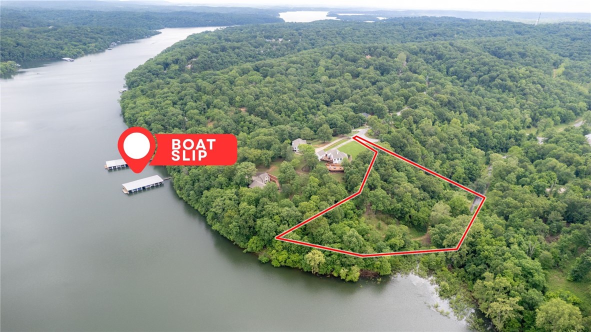 Mountain Lake Estates Lot with 10 x 24 ft Boat Slip! This 2 Acre Lot has 274 ft of Beaver Lake Frontage and a beautifully secluded wooded setting. Enjoy access to Beaver Lake from your backyard.  Boat slip on Community Dock 1 Slip 7, includes boat lift and a private locker. The property is a perfect setting for your lake home build with electric/gas/water at street. Located in sought after Lake Community just a short drive to Downtown Rogers shopping, dining, and entertaining. Don’t miss out on this fantastic lakefront opportunity!