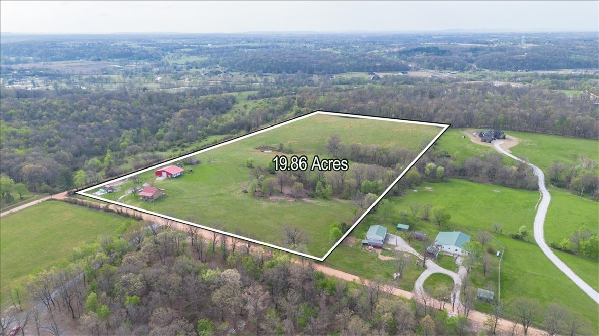 Discover the perfect blend of modern style and working farm utility on 19.86 pristine pasture acres. This stunning farmhouse, completely remodeled in 2018, offers timeless character with the peace of mind of new construction.
The property features a versatile 40x60 shop structure, boasting a 40x40 enclosed interior with a 14ft automatic door—ideal for an RV, boat, or professional workshop. The remaining footprint provides a deep integrated overhang for sheltered equipment storage. Reliability is built-in with two wells, including one installed within the last year to support the home and land.
Perfectly positioned near Cave Springs, the world-class amenities of Bentonville, and the convenience of XNA, this estate offers the quiet life without sacrificing accessibility. Whether you’re raising livestock or seeking a private retreat, this is a rare find in NWA. Experience the freedom of the farm with all the modern comforts you crave.