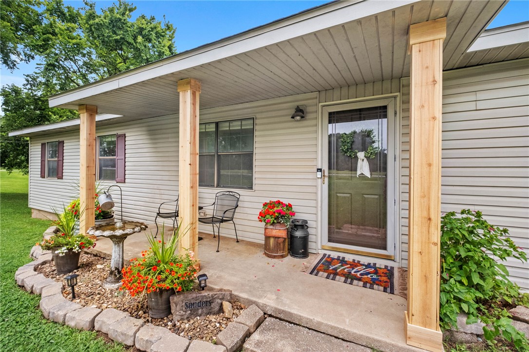 Rare 5.4-acre property in the heart of Northwest Arkansas! This well-maintained Lowell home offers the perfect blend of country living and convenience, just minutes from Rogers, Bentonville, Springdale, Fayetteville, and I-49. Originally built around 1960 and extensively remodeled in 1990, it features original red and white oak hardwood floors, a new roof, new HVAC, city water, and a private well (not currently in use). Multiple powered outbuildings include a workshop, finished she shed, unfinished tiny home, and loafing shed with covered storage. The fenced front acreage is open and usable, while the back widens to provide additional space that could be cleared for a future shop or homesite (buyer to verify). The wooded rear offers privacy and room to ride four-wheelers. No HOA. A rare opportunity to own acreage, character, and versatility in a prime Northwest Arkansas location!