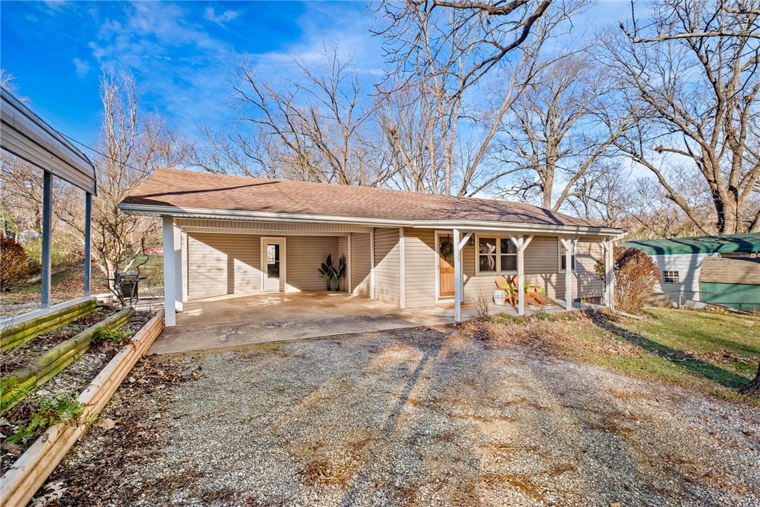 Great LAKE VIEWS on Beaver Lake! Perfect for an Airbnb or a primary residence! Although technically not lake front, the yard has a gentle slope and when the lake is high the water comes up to the edge of the yard! This move in ready home has 3 bedrooms, PLUS a separate office, PLUS a separate bonus room, PLUS 2 living areas & multiple outdoor living spaces to enjoy with VIEWS! Easy main-level living with an open layout in the kitchen and living room, 2 bedrooms, full bathroom, mud room and a separate office. Downstairs the finished walk out basement provides a lot of extra space with the second living area/game room, bedroom, full bathroom and bonus room (could be a 4th bedroom but no window). The basement walks out to another patio with lake views! The neighborhood boat launch is around the corner with easy access to the lake. 2 car attached covered carport, plus another carport with power & lights and a parking pad which could be used for RV or boat parking, PLUS 12x16 storage shed with power & lights.