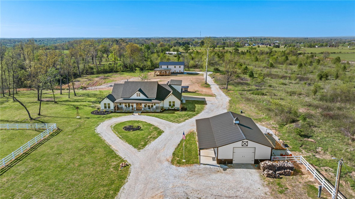 Let your story continue here!  This property consists of 2 homes & a large shop on 4 acres!  The main house, built in 2024, is a farmhouse-style home with 3120 sq ft & offers 4 first-level bedrooms, 3 baths & an office. Upstairs you'll find a bonus room or 5th bedroom with its own bath. Additional features include a gourmet kitchen with vented gas stove, large walk in pantry, a nugget ice machine, a drop station, wood burning stove, outdoor fireplace, & a storm shelter in the garage.  The second home was built in 2026 containing 1580 sq ft, 3 bedroom/2.5 bath, full kitchen, oversized attached garage & an expansive covered deck overlooking the yard.  In addition to the two homes, there is a 30 X 50 shop with a covered patio. Chicken Coop behind the main home conveys. The roads to the home are scheduled to be paved in the near future.  This one is a must see.  Prime location just minutes to Pinnacle shopping and restaurant area.  Schedule your private showing today.