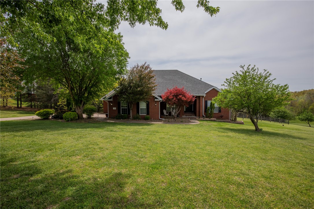 Tucked away on 2.8 private acres, this beautiful home offers the perfect blend of peaceful living and unbeatable convenience—just minutes from I-49, downtown Bentonville, and the Walmart Home Office. Enjoy your own backyard retreat featuring a sparkling saltwater pool with cool decking, ideal for relaxing or entertaining, while inside a thoughtfully designed split floor plan is enhanced by custom shutters, rich wood flooring, and stylish tile throughout. Expansive double decks provide the perfect space for hosting gatherings or unwinding in a serene setting, and the finished lower level includes a spacious game room along with extra storage. Best of all, lawn care and pool service are included, giving you more time to enjoy everything this exceptional property has to offer.