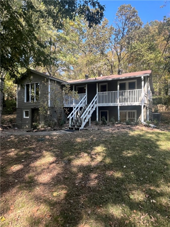This beautiful 2 story home fully renovated, has 4 bedrooms, 2 full bathrooms and it sets on 1 acre, tucked away but visible from Hwy 71 with wooden bridge crossing and a seasonal creek.  1960's cottage with some wood floors, knotty pine lined walls and a native stone fireplace (no wood burning). It  has vaulted ceiling in living room. It  has french doors that open to outdoor concrete landing with pretty old stone wall and landscaping.