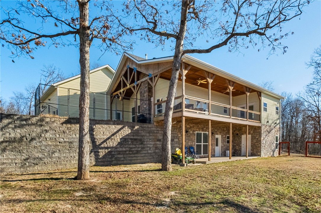 Nestled quietly outside city limits, but within 35 minutes of Downtown Bentonville, this home blends country charm with modern comfort. The home features a paid off whole home solar system and an insulated 30x40 shop with mini split perfect for tools, vehicles or hobbies. The generous floorplan spans over 2,700 square feet with three bedrooms and two and a half baths, giving a perfect balance of private and shared living areas. The main level features the primary bedroom, and the other two bedrooms are downstairs. Whole Home Solar System installed in 2025 and conveys with the property, with the exception of the battery backup system. The property’s large acreage suits multiple uses, whether you want room for gardens, outdoor entertaining, animals, or future outbuildings. Additional hookup for washer/dryer downstairs. Water system features a Softener, Iron Filter, Sediment Filter, UV Filter and Reverse Osmosis drinking system in the home, and is serviced by Culligan Water.