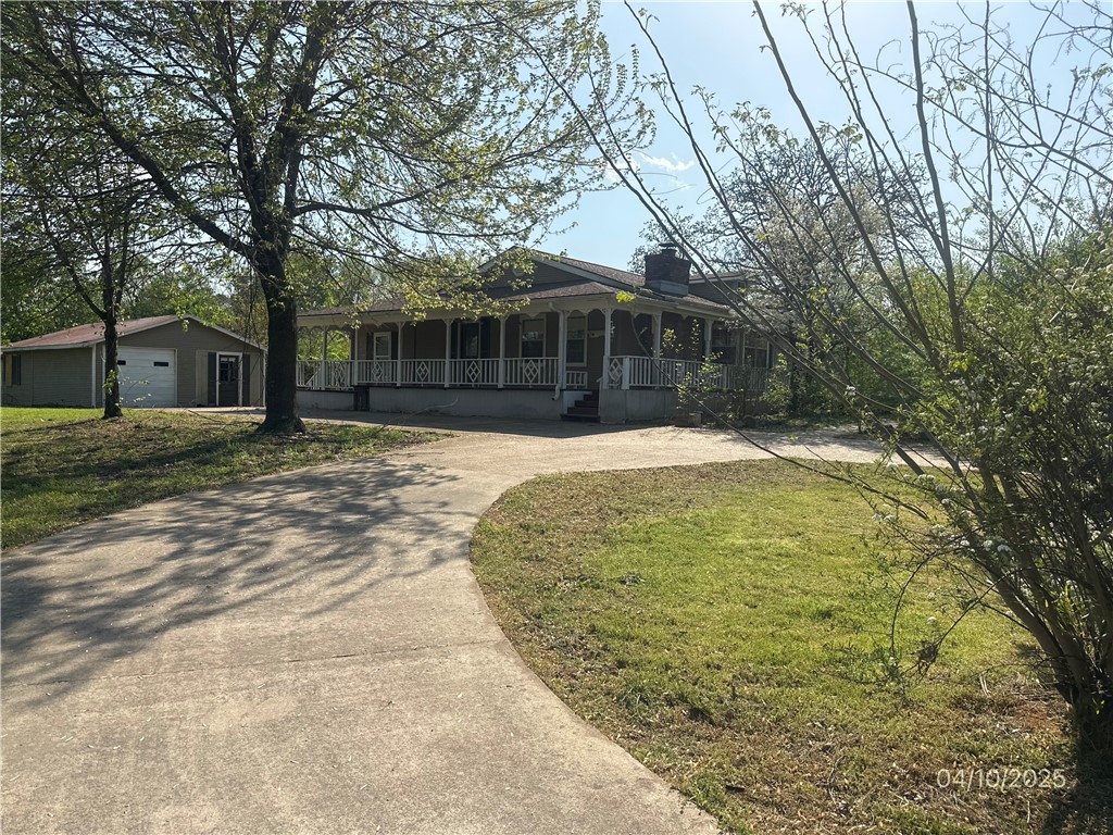 Spacious 3 bedroom, 3 full bath home with a wrap around covered porch. There is a nice circle drive in the front.  Behind the house is an enclosed deck. Meandering stone pathways leads to a nice patio in the back yard. Newer central heat/air unit. Garage/workshop/greenhouse combo, plus a little cabin and storage shed in the back of the property with so many potentials. A huge solar panel ready to save you on your electricity. With some love and care this home will be back to its stunning potential. This home is a foreclosure. All offers must be submitted at www.vrmproperties.com. Agents must register as a user, enter the property and click on ''start offer''.