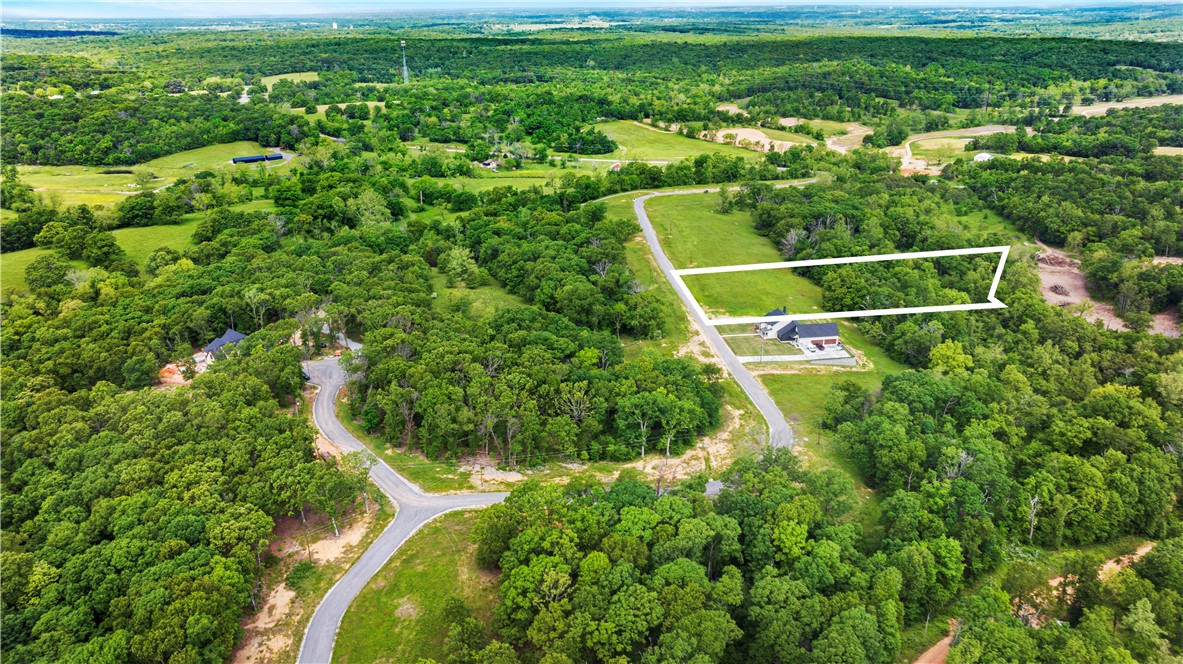 Welcome to Hill Country Estates—a thoughtfully planned subdivision where luxury living blends seamlessly with the beauty of the Ozarks. Set along a picturesque, winding drive, this community offers private 3+ acre lots surrounded by rolling hills, mature hardwoods & peaceful natural scenery. Each lot is gently sloping & partially wooded, providing flexibility for thoughtful home placement & stunning views. Carefully designed covenants require min. 3,000 sq. ft. residence w/3-car garage, preserving long-term value & architectural integrity. Enjoy the tranquility of country living while remaining just minutes from shopping, dining & everyday conveniences—less than 20 minutes from downtown Bentonville & just 25 minutes to NWA Airport (XNA).  Hill Country Estates delivers a rare combination of privacy, space & accessibility for those seeking an elevated lifestyle. Buyers may also explore AR Public School Choice, allowing application to public school districts outside the zoned district, subject to avail. & deadlines.