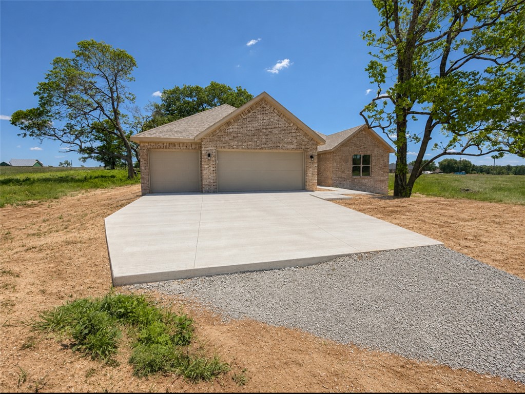 New construction home situated on 3.6 +/- acres offering 4 bedrooms, 3.5 bathrooms, and a functional open floor plan. Features include a spacious living area, large kitchen with ample cabinet and counter space, split-bedroom layout, and a primary suite with walk-in closet and private bath. One additional bedroom includes a full en suite bathroom, making it ideal for guests or multi-generational living. The property offers mature trees, open space, and room for outdoor enjoyment, gardening, or future improvements. Enjoy the privacy and peaceful setting while still being conveniently located to nearby amenities, schools, and highways.