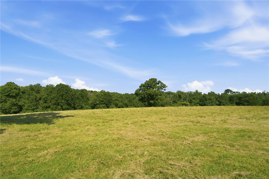 Discover 21 beautiful acres just outside the city limits of Siloam Springs, offering the perfect balance of privacy and convenience. Located just over a mile from Highway 412 with all paved road access to the property entrance, this land features a deeded easement from the main road. Utilities including gas, and electric are available at the road, onsite well and septic needed. Enjoy breathtaking sunsets, abundant wildlife, and a desirable mix of wooded areas and open pasture. Ideal for building your dream home or for future development as Siloam Springs continues to grow. Minutes from the Siloam Springs Kayak Park and the Illinois River, perfect for floating and smallmouth fishing. Only 10 minutes to historic downtown Siloam Springs, 25 minutes to I-49 and Springdale, and approximately 13 minutes to the new 612 Bypass upon completion. Country living with shopping and restaurants just minutes away!