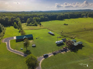 What a unique opportunity!  This stunning home is rustic and inviting on the outside yet beautiful and modern on the inside with a large open living area that features a eyecatching stone fireplace as its focal point.  The open dining area adjoins a spacious kitchen with granite counters, beautiful island, and abundant storage!  There is a gorgeous master with a huge garden tub, aunique walk in shower, and a closet you won't believe!  Each of the additional bedrooms feature a large walk in closet and private full bath!  There is even a private office area!  This home also features a guest house, large shop and 21.23 gorgeous country acres!