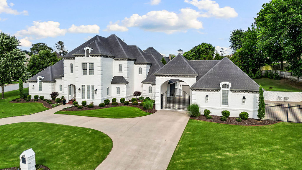Stunning. Magnificent. Grand. Majestic. Elegant. However you choose to describe it, one thing is certain—this home has charm & character that reflects pride of ownership!  Perfectly positioned across from a breathtaking 16-acre POA-maintained park with walking trails, a picturesque bridge, and direct Greenway access, the setting is as impressive as the home itself. Inside, a dramatic staircase makes an unforgettable first impression, complemented by impeccable maintenance, fresh paint, genuine hardwood floors, and timeless craftsmanship throughout. Multiple garages provide room for vehicles, hobbies, and toys, while the sparkling pool is perfect for relaxing on warm days. An elevator adds everyday convenience, and a hidden secret room behind a safe is guaranteed to be the conversation piece of every gathering. Extraordinary homes are rare. Finding one with an equally extraordinary setting is even rarer.