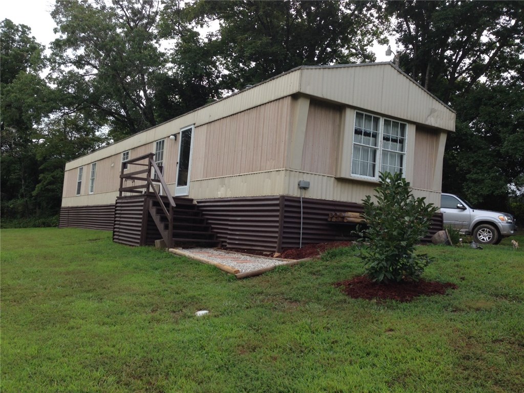 Country living with beautiful views! This move in ready mobile home that is in great condition is being sold As-Is with right of inspection. It has been recently remodeled and sits on 4.25 acres. This home is a perfectly centralized hunting space and contains plenty of roaming deer and turkey! It contains a full kitchen and utility room with fridge, washer, and dryer which all convey. It features a fully insulated and electric 12x30 detached garage/workshop and includes newer Water Heater and HVAC. Mobile home is permanently affixed. Just 25 minutes from Fayetteville! Come see this great piece of property and all it has to offer!
