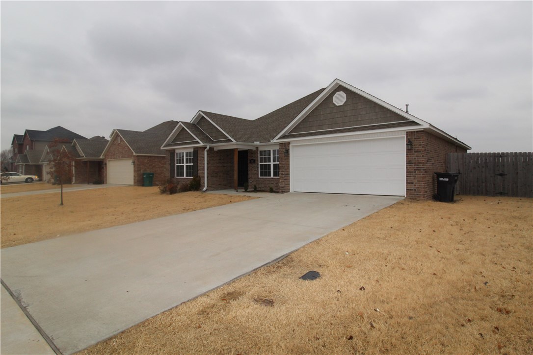 This beautiful home is perfect for a first-time home buyer! Great split plan lay-out with vaulted ceiling in living room. Beautiful cherry cabinets in large eat-in kitchen. Jacuzzi tub, shower in master bath, and large walk-in closet in master suite. A lot of house for the price with privacy fence around back yard with deck, landscaping in front yard. Nestled in the heart of Rogers, walking distance to elementary school and easy access to 71-B and I-49