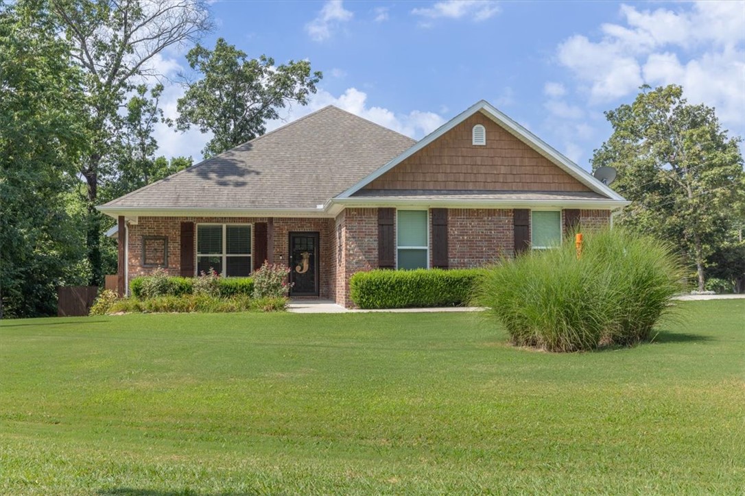 A beautifully situated all brick home on a level corner lot, meticulously maintained with a perfectly shaded deck in a backyard surrounded by mature trees in adventurous Bella Vista. This is the ONE you’ve been waiting for! The 3 bedroom/2 bath spacious layout features an enormous master suite with a vaulted ceiling, large shower with a bench, jetted tub & walk-in closet. From the generous size covered front porch into the open living area with a warm cozy fireplace in the living room & stainless appliances including convection range, granite counters, under-cabinet lighting & pantry in the kitchen. Tucked away you’ll find 2 more bedrooms & a bath, spacious storage closets & a laundry room. Notable features to love include main area wood-look tile floors, carpet only in the bedrooms, insulated garage doors, oversized driveway and garage, gutters with screens, propane for the fireplace only & on sewer. Convenient to Metfield Golf Complex, nearby Blowing Springs, OZ Trails Bike Park, bike lift & Lake Brittany Dam.