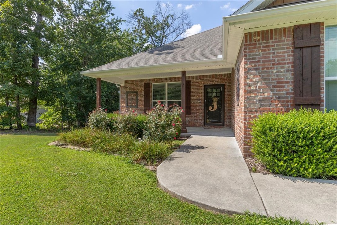 A beautifully situated all brick home on a level corner lot, meticulously maintained with a perfectly shaded deck in a backyard surrounded by mature trees in adventurous Bella Vista. This is the ONE you’ve been waiting for! The 3 bedroom/2 bath spacious layout features an enormous master suite with a vaulted ceiling, large shower with a bench, jetted tub & walk-in closet. From the generous size covered front porch into the open living area with a warm cozy fireplace in the living room & stainless appliances including convection range, granite counters, under-cabinet lighting & pantry in the kitchen. Tucked away you’ll find 2 more bedrooms & a bath, spacious storage closets & a laundry room. Notable features to love include main area wood-look tile floors, carpet only in the bedrooms, insulated garage doors, oversized driveway and garage, gutters with screens, propane for the fireplace only & on sewer. Convenient to Metfield Golf Complex, nearby Blowing Springs, OZ Trails Bike Park, bike lift & Lake Brittany Dam.