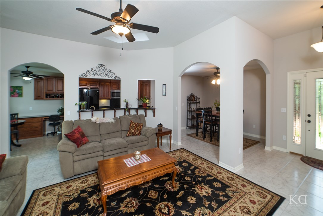 SECLUDED, PEACEFUL living just minute from I-49. All BRICK, OPEN & BRIGHT w/pretty archways making this not a "cookie cutter" home, gas fp, lots of natural LIGHT. Spacious kitchen has custom cabinets, flecked granite, under cabinet lighting and prep sink. Eat-in kitchen, built in desk area, laundry room. Relaxing sitting area in Master Suite w/patio access. Roomy master bath and walk-in closet. Awesome flat back yard to host gatherings or let the kids play! Extra parking space on the side of the house