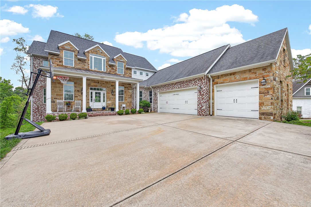 Experience luxury living in the prestigious Versailles neighborhood with this stunning custom-built home designed for both elegance and functionality. The open-concept kitchen, living, and dining areas create a seamless flow ideal for entertaining, while expansive windows showcase beautiful wooded views and fill the home with natural light.
Upstairs, the private primary suite offers a relaxing retreat with a spa-like ensuite bathroom, while two additional bedrooms are connected by a Jack-and-Jill bathroom. The finished walkout basement adds exceptional versatility with a large bonus room, abundant storage space, and a gym area already plumbed and ready for the option of a future kitchenette—perfect for guests, multigenerational living, or entertaining. You will also find two additional bedrooms and full bath.
Enjoy privacy, scenic surroundings, and the opportunity to also add more privacy or possibilities with the adjoining lot available for purchase for $200,000. See MLS # 1345393.