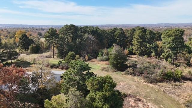 Beautiful 25-Acre property located just 10 minutes from town, offering a prime blend of open space and convenience. Land is mostly cleared with gentle contours, ideal for new construction, livestock, or recreational use. A 50 x 40 barn sits on the property, providing excellent storage, workshop potential, or space for animals- an outstanding feature for anyone seeking agricultural or hobby-farm opportunities. Property includes a scenic pond and an older home with renovation potential. Essential utilities are already in place on the property, including a water meter, electric meter, and fiber-optic internet. A storm shelter provides additional peace of mind. Fenced on three sides and ready for your vision, this tract is perfect for a homesite or rural retreat. A two-story frame is also available for purchase and can remain or be moved at the buyer's preference. This land is available split into 3 additional listings. MLS 1339791, 1339794, 1339792.