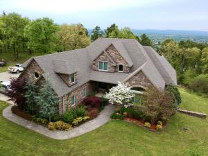 At the foothills of Mt. Magazine and overlooking Paris Reservoir sits this immaculate 6,861 (sqft total) home Nestled on 6.73 acres with tall trees and pristine landscaping. Enjoy the spectacular views with over 1,000 sqft of deck and covered seating complete with wood burning fireplace to warm up. Inside you are welcomed with floor to ceiling windows seamlessly bringing together the open concept kitchen, living, and dining room areas.  As you continue, features include granite countertops, tall ceilings, gas fireplace, crown molding, stainless steel top of the line appliances, builtins, and hardwood floors throughout entire home. Safety features include security system and built in safe room in basement. 5 Bedrooms 3 full baths 2 half baths, 3 bonus rooms plus game room, and 3 Car garage.