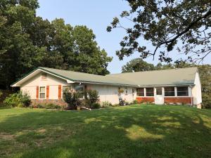 Check out the pretty setting on this 3 or 4 bedroom home in quiet country subdivision. Huge family room with stone fireplace, living room with cathedral ceiling, large master bedroom, sun porch and enclosed deck, large basement workshop, landscaped, wooded, large trees, picnic pavilion, pond, winter view and only minutes to town! You really need to check this one out! All #'s approximate.