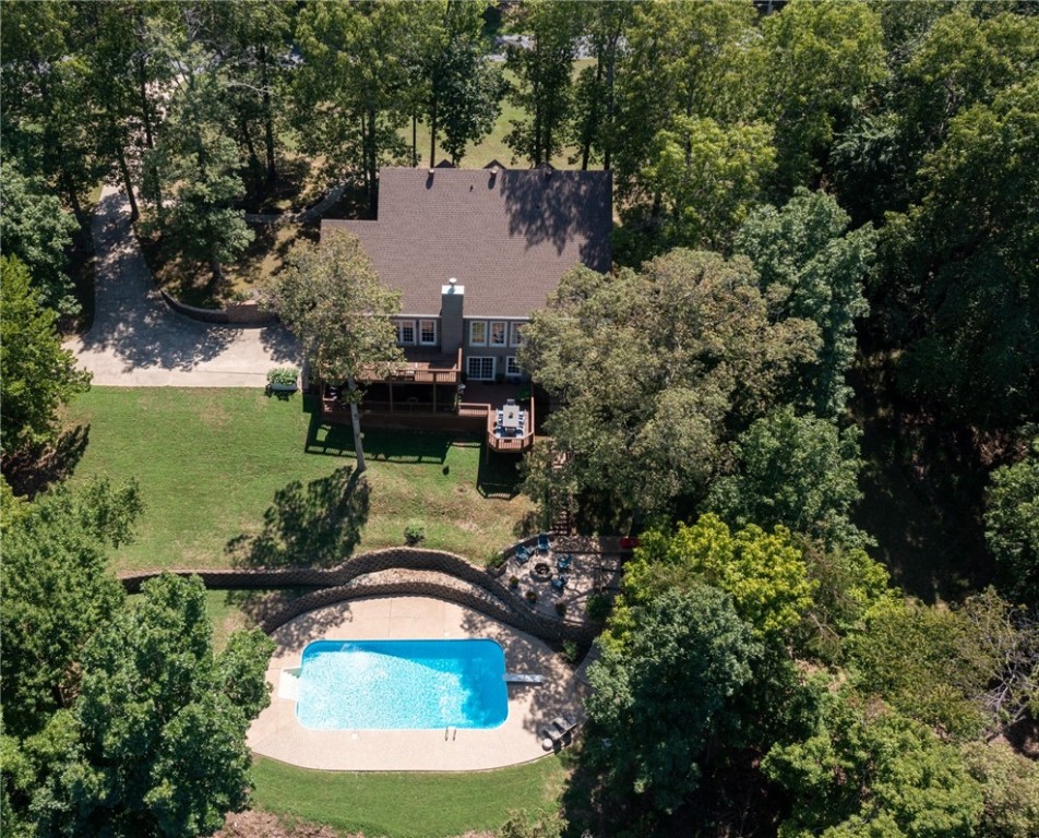 Boat slip (10x26) in community dock conveys (bill of sale) with property. Lake front 2.5 acres. Decks, porches, 20x40 swimming pool, fireplace with insert, Marathon water heater, granite, wood floors, quality trim.  Master is on the main level. 2nd level has loft walkway overlooking the living area below. Gated subdivision. Contact agent for gate code. Close to town with easy access. Finished walk-out basement has 2BR, 1Ba, game room, hospitality bar, exits to large deck with view of swimming pool and lake. the 1,399 square feet of the finished basement is included in the total heated space.