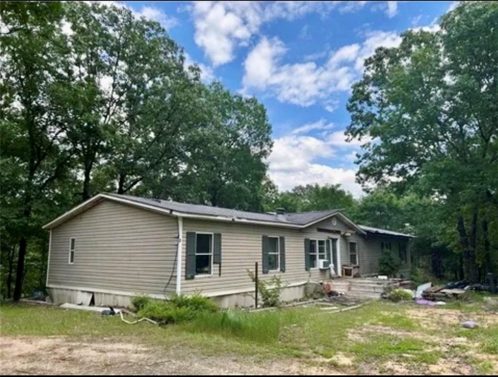 Doublewide mobile home situated on 10.10 serene, private acres in beautiful Dover, AR. This property offers a rare opportunity for the right buyer to fix it up and reap the rewards. Enjoy peaceful country living with abundant wildlife and scenic views. Relax on the front deck with your morning coffee while taking in the quiet surroundings. A must-see for investors or those seeking a private rural retreat.