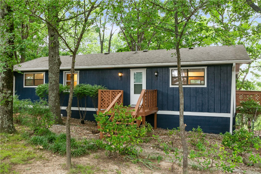 Welcome to peaceful Beaver Lake living! Nestled in the desirable Vista Shores subdivision, this beautifully refreshed 3-bed, 1.5-bath home sits on approx .54 acres, offering privacy, mature trees, and a serene natural setting. Recent updates include fresh in/exterior paint, new floors, roof replaced 2019, making this home move-in ready. The versatile basement provides approx 534 sq ft of flex space-perfect for, game room, home office, fitness room, or guest retreat! Step outside to the spacious decks where you can relax, entertain, and enjoy the peaceful surroundings. The oversized car garage offers plenty of room for vehicles, outdoor equipment, and extra storage. Located just mins from Beaver Lake, boat launches, trails, fishing, and endless outdoor recreation, this home offers the perfect combination of comfort, convenience, and the relaxed lake lifestyle. Whether you're searching for a full-time residence, weekend getaway, or investment opportunity, this Northwest Arkansas gem is ready to welcome you home!