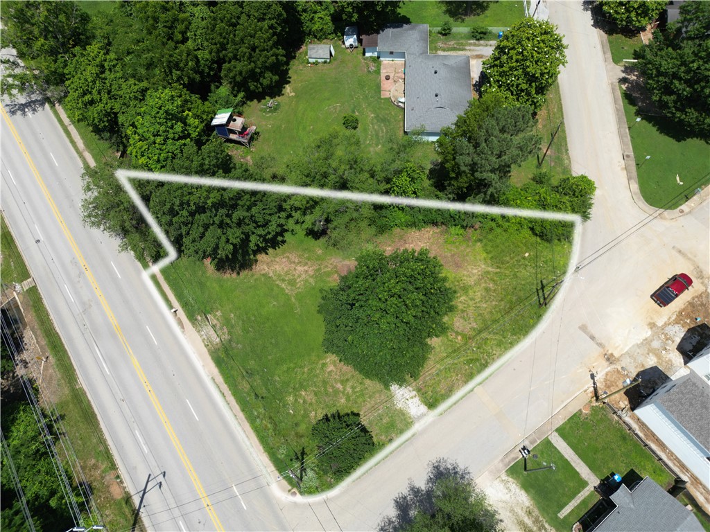 This prime 0.35-acre property at 602 W 15th Street in Fayetteville, Arkansas, offers a rare, shovel-ready development opportunity with full City of Fayetteville approvals already in place to construct seven three-story townhomes. All entitlement work is complete, and the sale includes comprehensive engineered development plans, horizontal cost estimates, and architectural plans for the proposed townhomes, allowing for immediate construction in a high-demand area. Ideally situated just steps from Baum-Walker Stadium at the corner of 15th and Razorback Road and minutes from Bud Walton Arena, the site is also within easy walking distance to the University of Arkansas campus, providing exceptional access for students, fans, and professionals. Its convenient proximity to I-49 via nearby exits ensures quick connectivity throughout Northwest Arkansas, making this a truly outstanding investment in one of the region’s hottest markets with strong rental potential driven by university and game-day demand.