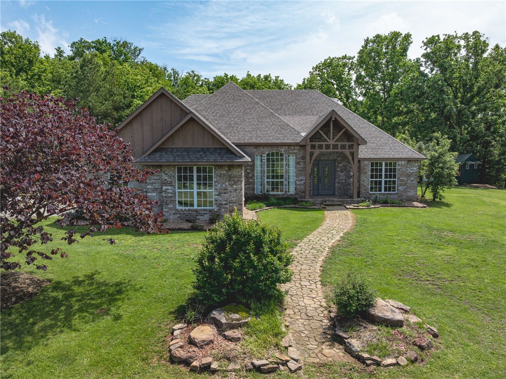 Peaceful country living just minutes from Fayetteville - this 20-acre homestead offers a rare blend of modern comfort, usable land, and rustic charm. The single-level home features a split floor plan with hardwood floors throughout and abundant natural light.  The kitchen is beautifully updated with granite countertops and has a dining / sitting area with a cozy fireplace.  A screened in sunroom provides year-round enjoyment of the landscaped backyard and woods.  The private primary suite is separated from the secondary bedrooms, while two additional bedrooms and a full bath offer great flexibility for guests, office, or hobby space.  A new roof in 2024 adds peace of mind. Outside, enjoy the rolling pastures, wooded areas, and a pond, along with a mini apple orchard and plenty of room to garden or expand.  A rustic, handcrafted log cabin adds character to the property. A turnkey country property with modern updates, character, and room to live the homestead lifestyle-yet still convenient to Fayetteville amenities.