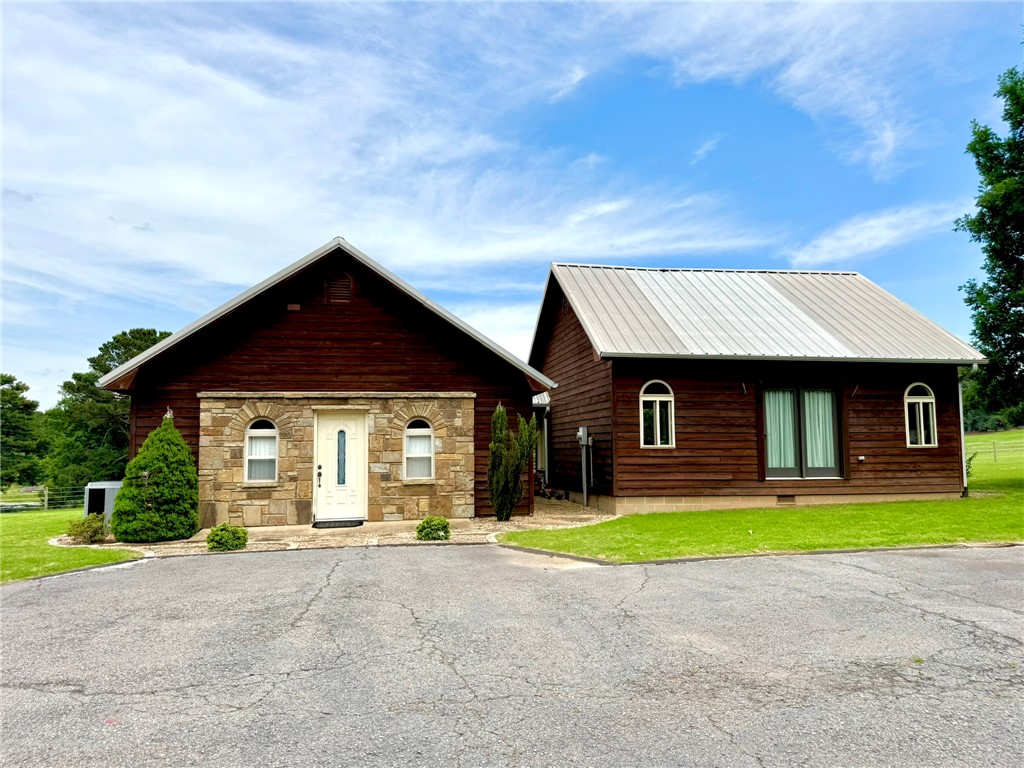 Bring your horses! This unique property features a 1-bed, 1-bath home plus a separate studio apartment on 10 beautiful acres. This property is ready for your horses with specialty horse fencing, cross-fencing, a loafing shed, pond, and self-watering system. There's plenty of room to add a barn and riding arena.  Watch your horses graze from the back deck while enjoying peaceful views of the pasture and pond.

The property includes a cozy 1-bedroom, 1-bath home plus a separate studio apartment with endless possibilities for mother-in-law quarters, guests, college student, Airbnb, office, or rental income. Both buildings offer open-concept living spaces, cedar interiors, cedar closets, and back decks with pasture and pond views. Wildlife, mature trees, attractive landscaping, a carport, storage shed, and a secluded dead-end drive complete this private country retreat designed for horse lovers.