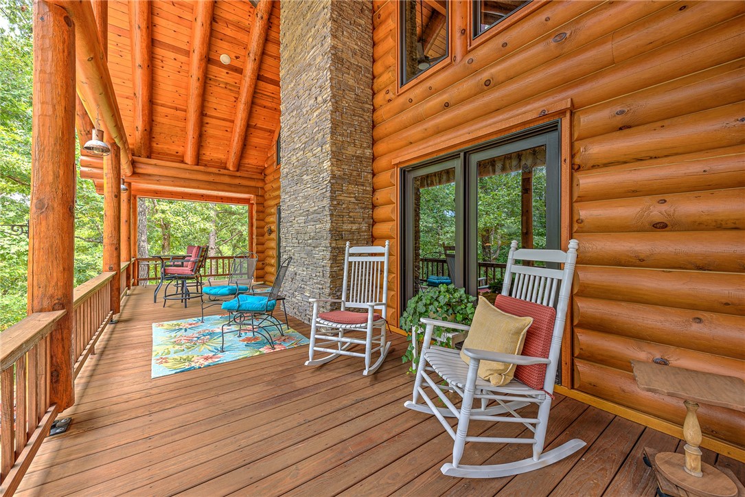 Beaver Lake Cabin Retreat with Guest House & Workshop – 5 Minutes to Clifty Boat Ramp Escape to your own Ozark haven on approx. 20 wooded acres between Eureka Springs and Rogers. Just 5 minutes from the Clifty boat ramp, this property delivers year-round access to fishing, boating, hiking, and lake fun. The stunning log cabin offers an open living area with a cozy fireplace and a main-level primary suite with private bath. Upstairs, a spacious loft with its own bathroom makes an ideal bunkroom, game room, or second living space. Relax on the wrap-around porch overlooking peaceful wooded views—perfect for morning coffee or evening cookouts. A separate guest house adds excellent rental or in-law potential, while the 26’x30’ workshop/garage in the walk-out basement provides great storage or project space. With quick lake access, abundant wildlife, and easy proximity to downtown Eureka Springs, this is theultimate Beaver Lake lifestyle retreat.