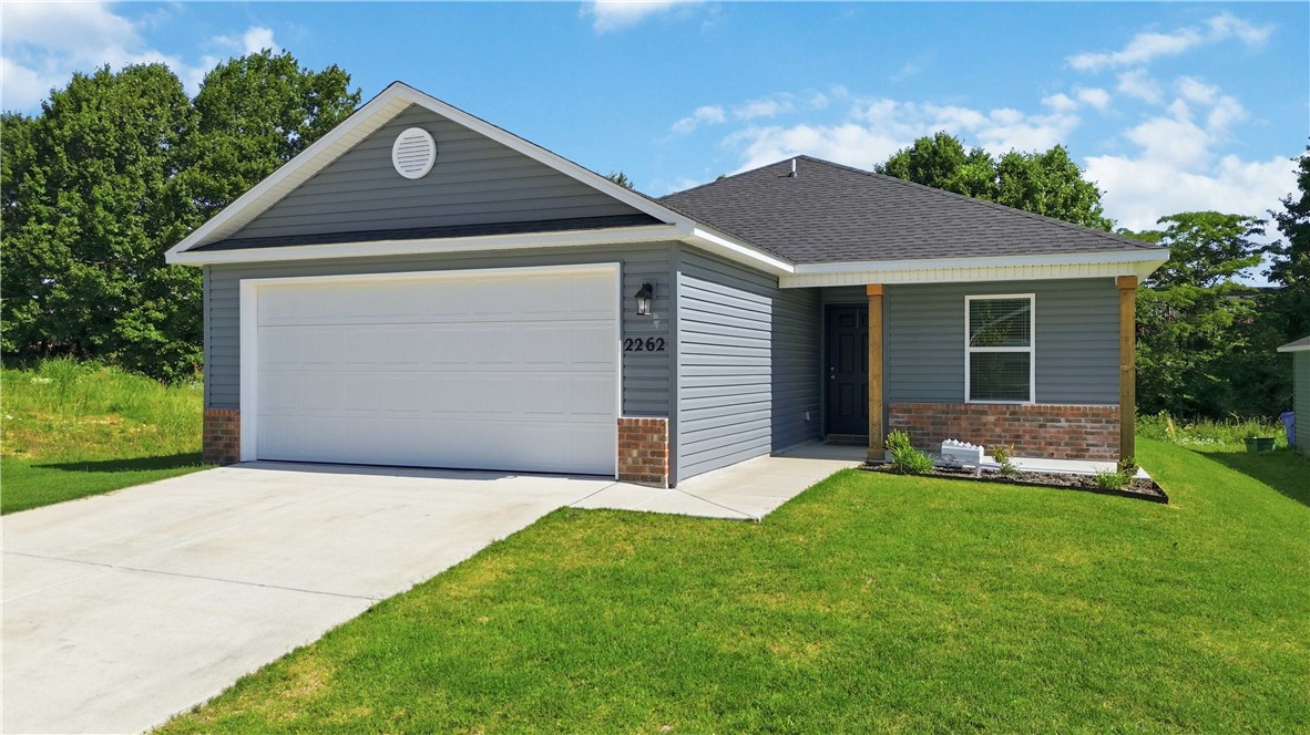 Discover modern living at 2262 S Ouachita Dr in Riverside Village! Built in 2024, this charming Cypress plan offers 4 bedrooms, 2 bathrooms, and an open-concept layout filled with natural light. Enjoy great curb appeal with a covered front porch and landscaped front yard. The spacious living and dining areas flow into a beautifully designed kitchen featuring energy-efficient appliances, ample counter space, and a large pantry. Thoughtful upgrades include blinds, gutters, security system, attic storage and garage door opener. The home also offers a 2-car garage and a private backyard backing to the woods with a patio perfect for relaxing or entertaining. Conveniently located just 10 minutes from the University of Arkansas and near White River access, this property is ideal for homeowners or investors alike. For a video tour https://youtu.be/RZdXx3DXX_Q