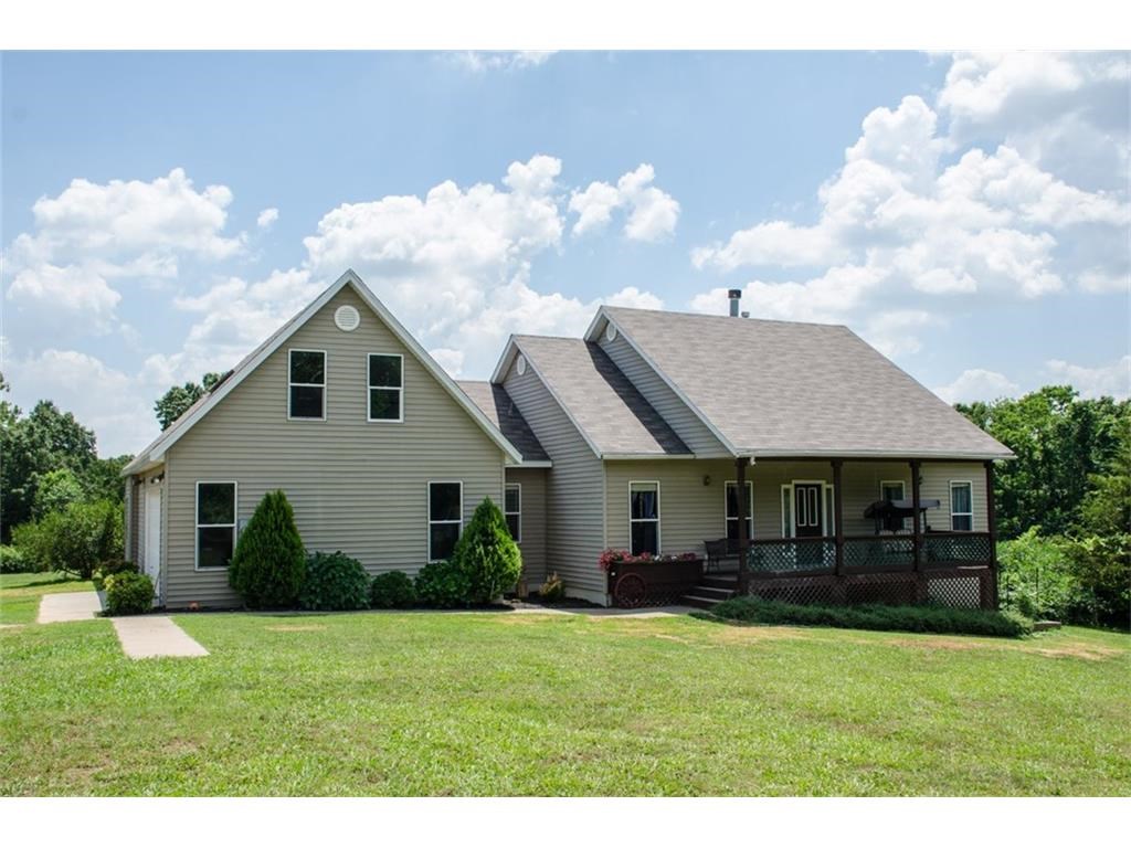 Custom built on 10 acres just 12 miles from Wal-Mart Home Office.  Wide country porches front and back, 3 bedrooms, 3.5 baths plus bonus room.  Two dining areas, open floor plan, gracious columns, split layout.  If you want privacy and room to roam, this is it!