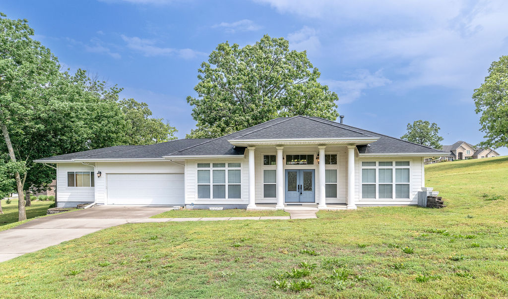 Custom-built ranch-style home by the Stitt Group in desirable West Ridge Estates offering 3 bedrooms, 2 bathrooms, and 2,338 square feet on a spacious 0.77-acre lot. Features include engineered wood flooring, open-concept living area with gas fireplace, skylit kitchen, large walk-in closets, stained-glass windows, and vintage chandeliers. Primary suite includes a soaker tub and walk-in shower. Exterior highlights include large front porch columns, wider eaves, and an attached 2-car garage with epoxy-coated floor and workshop space. ENERGY STAR® certified for comfort and efficiency​​‌​​​​‌​‌​​​‌‌​​​‌‌‌​​‌​​‌‌​​​​ throughout.