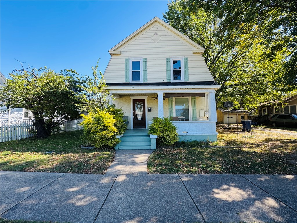 Historic 1906 3-bedroom home in downtown Siloam Springs. Original hardwood floors, beautiful staircase, and classic woodwork blend with modern updates throughout. Remodeled upstairs bathroom, updated kitchen with new tile flooring, countertops, refrigerator, and stove, plus a custom hidden pantry in the oversized dining room. New HVAC system. Detached climate-controlled studio/she-shed with mini-split offers the perfect space for an office, gym, art studio, or guest retreat. Walking distance to downtown Siloam Springs and John Brown University. Historic charm, modern convenience, and an unbeatable location.