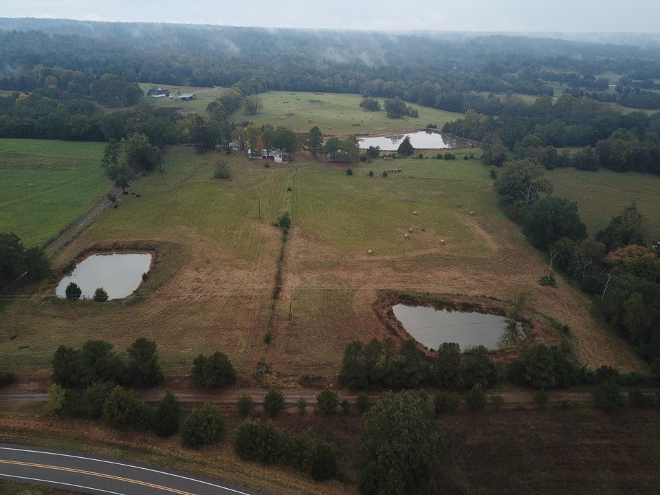 This 43-acre tract features expansive pasture, three stocked ponds, and dramatic mountain scenery.
The completely fenced estate includes a large workshop, a pole barn and a pump house with added storage space. A back deck offers a tranquil vantage point to take in the green pastures and mountain views. The mobile home has been expanded and provides three bedrooms and 2.5 baths, with accessibility accommodations.
