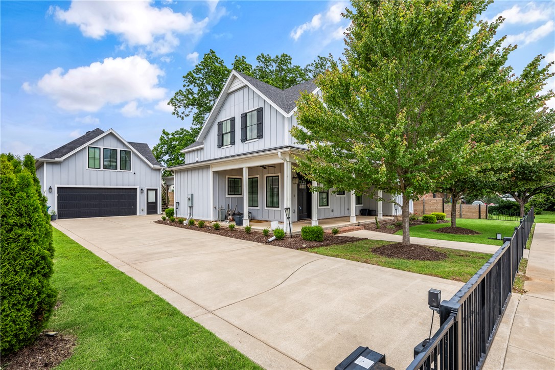 RARE FIND!  Downtown Bentonville Home with POOL! Yes, you CAN have it all!  This custom-built home combines timeless architectural character with modern luxury, all within an easy walk to the restaurants, coffee shops, trails, and entertainment that make Downtown Bentonville so popular!   Inside, the open-concept floor plan is designed for both everyday living and entertaining.  The upstairs primary suite offers a private retreat with a dream closet! Additional bedrooms provide flexibility for family, guests, or a home office.  Backyard feels like a private resort with a covered patio overlooking a beautifully designed pool perfect for lounging, outdoor dining, and entertaining.  Detached garage with a fully finished versatile space above that can serve as a guest suite, income-producing rental, home office, fitness studio, or creative workspace. Complete with its own entrance, it offers exceptional flexibility and value!  This home truly has it all in the highly sought after location of Downtown Bentonville!