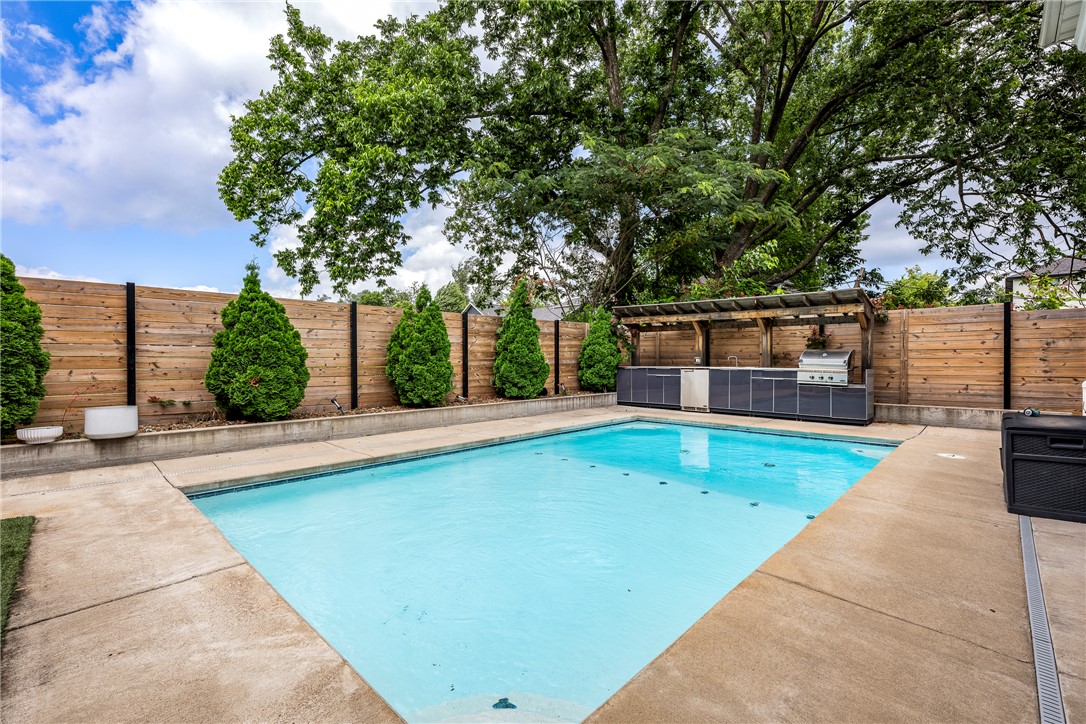RARE FIND!  Downtown Bentonville Home with POOL! Yes, you CAN have it all!  This custom-built home combines timeless architectural character with modern luxury, all within an easy walk to the restaurants, coffee shops, trails, and entertainment that make Downtown Bentonville so popular!   Inside, the open-concept floor plan is designed for both everyday living and entertaining.  The upstairs primary suite offers a private retreat with a dream closet! Additional bedrooms provide flexibility for family, guests, or a home office.  Backyard feels like a private resort with a covered patio overlooking a beautifully designed pool perfect for lounging, outdoor dining, and entertaining.  Detached garage with a fully finished versatile space above that can serve as a guest suite, income-producing rental, home office, fitness studio, or creative workspace. Complete with its own entrance, it offers exceptional flexibility and value!  This home truly has it all in the highly sought after location of Downtown Bentonville!