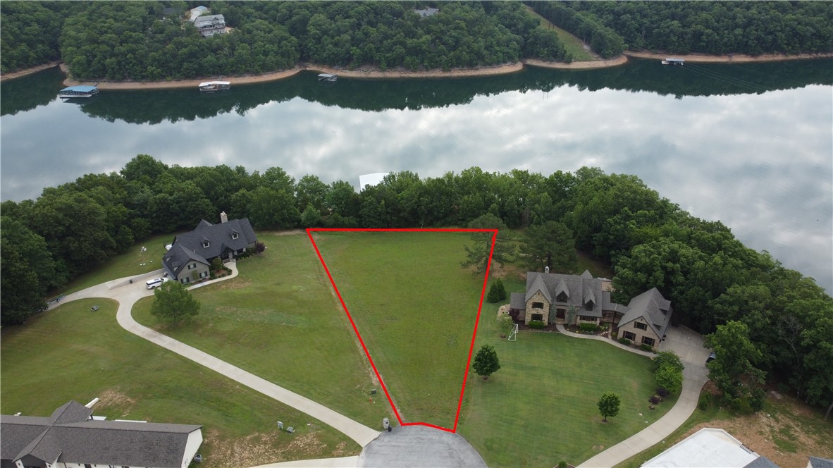 Impeccable lakefront lot, tucked away in Estates of Lakeway is now available! This gorgeous piece has a slip and heavy duty lift that conveys. Slip is in one of the community docks that is direct access from the property. Imagine living right in Coose Cove! Being able to take a 5 minute boat ride to Prairie Creek Marina, having dinner at the Captains Seat, and then go for an evening cruise! This property is truly a Lake lovers dream.