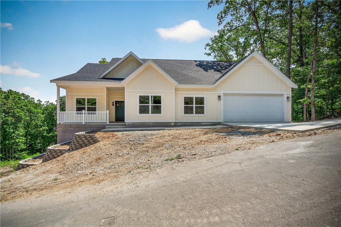 Gorgeous new construction 3 bedroom 3 bath home plus office! The open-concept layout is anchored by a gourmet kitchen with quartz finishes, custom cabinetry and large pantry. Natural light pours through the rear windows, highlighting the spacious floor plan and high-end flooring. Retreat to the primary ensuite for a spa-like experience with a huge walk in custom tile shower. Outside a covered deck provides a peaceful, wooded sanctuary. Plenty of headroom in crawl space to finish for a shop or additional storage  Home is perfectly located to all things Bella Vista and is in the Bentonville School Dist. Just right around the corner from the Back 40 trails and Lake Ann. Make your appointment today!