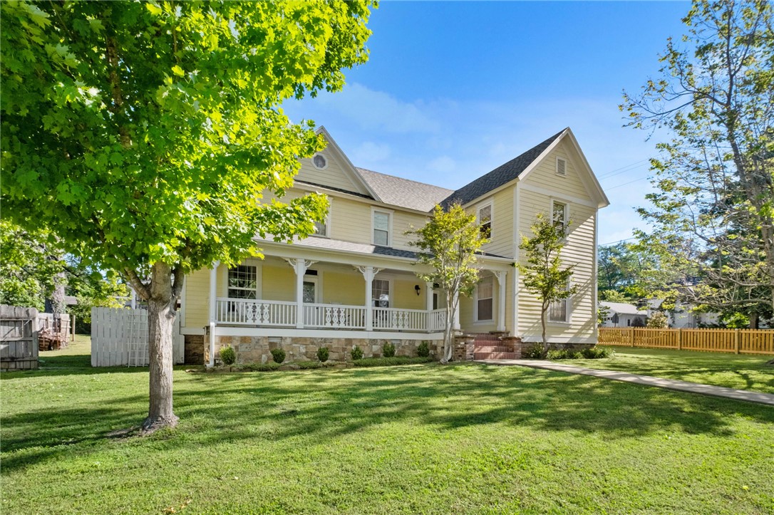 Step into a living piece of Arkansas history—where timeless charm meets modern ease. Built in 1857, this 4BR/2.5BA home in the heart of Prairie Grove welcomes you with a stunning front porch that instantly feels like home.

Inside, original hardwood floors and rich woodwork blend with thoughtful updates, including a renovated kitchen and baths, high R-value insulation, updated windows, smart thermostats, and a new roof (2024). A central wood stove and efficient HVAC ensure year-round comfort.

Outdoor living shines with a covered patio, cozy fireplace, fruit trees, and classic picket fence—perfect for relaxing or gathering. Set on a .47-acre corner lot with walkable access to downtown.

The 1,800 sq ft coach house—framed and dried-in—offers excellent potential for multi-generational living, STR income, or private guest space.

Historic character. Flexible living. A place to truly belong.