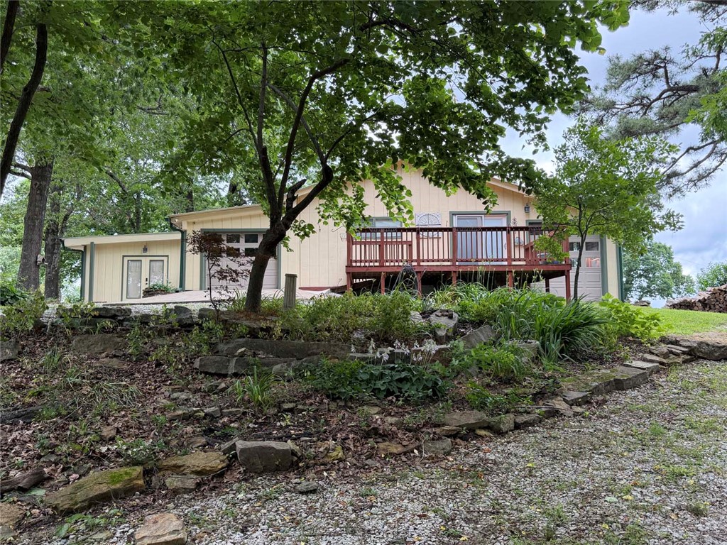 Located just south of Jasper, this 3 or possibly 4 bedroom 2-bath home sits on 5 gorgeous scenic acres with beautiful views. The property offers a unique opportunity with a separate living area featuring its own private entrance, previously used as an Airbnb rental, making it ideal for guests, supplemental income, or a home office. The home includes all appliances, a wood-burning stove, and a whole-house generator for added convenience and peace of mind. Multiple garages provide ample space for vehicles, ATVs, equipment, hobbies, or workshop use, while additional storage shed offer even more room for tools and outdoor gear. Enjoy the outdoors with 2 ponds, raised garden beds, fruit trees and plenty of usable land. Property also features a concrete slab for an additional shop or a place to park your RV. Whether you're looking for a full-time residence, vacation property, or home with income potential, this versatile Jasper property offers a desirable location, great views, and room to enjoy the Ozarks lifestyle.