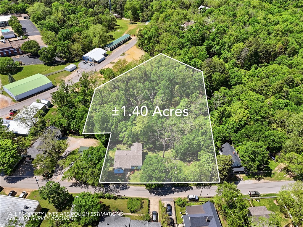 Beautiful Home in the Middle of Eureka Springs! This remodeled 4 Bedroom, 2 1/2 bath is ready to move in! Sitting on 1.4 Acres of Landscaped gardens, outdoor firepit, and brand new fenced in front yard.  Walk into an open floor plan with vaulted ceilings, hardwood floors, recessed lighting, gas fireplace with tiled hearth, and fully remodeled kitchen with brand new appliances.  Complete with cherry wood cabinetry, and granite counter tops.  Spacious screened porch featuring a vaulted wood-paneled ceiling, wood-finish flooring, lattice railing, and a ceiling fan for morning coffee!  Main bedroom with beautiful on suite on main floor. Fully finished basement! New flooring, complete with office space, and two more bedrooms, and full bathroom, walk-in closets.  Easy access lets you walk out to the backyard.  New roof in 2025, fresh paint throughout the home. Minutes from Downtown Eureka Springs. Beaver Lake not far, Table Rock Lake, and about 5 rivers in the surrounding area.