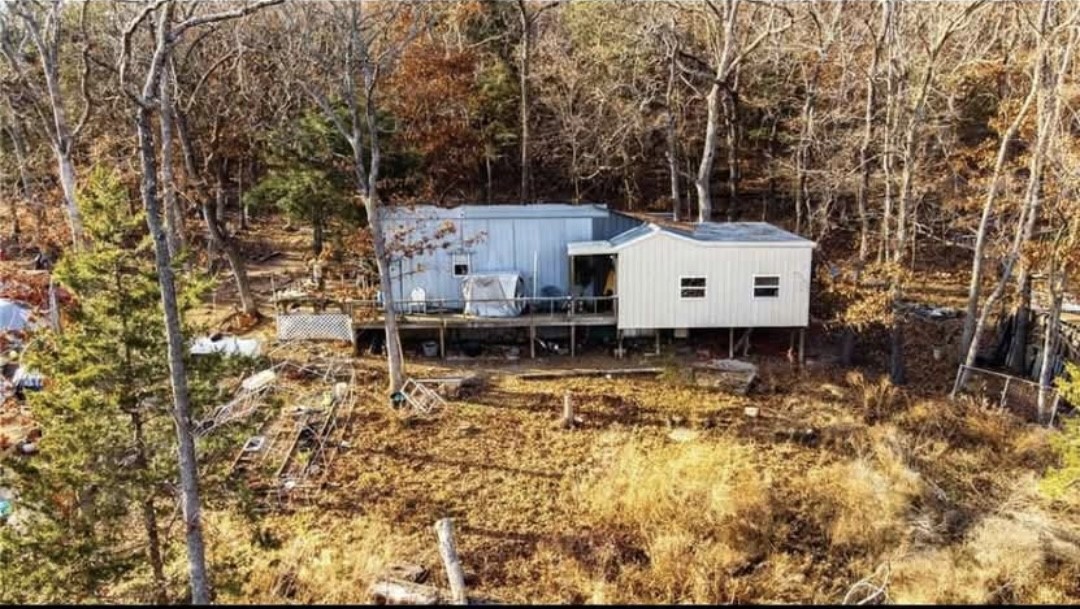 Escape the city life and enjoy nearly 7 beautiful acres in the Ozarks.  This home is 1151 sq ft and is surrounded by mature trees of many species including Oak, Walnut, Maple and Cedar.  Beautiful rock ledges.  Enjoy nature and peace and quiet.  The property is outstanding for hunting and is abundant with white tail deer and turkeys.  The property also has a new well and septic system, and a metal shop for storage.  This property is perfect for anyone wanting to get away from the city, but is close the the essentials as well.  Also could serve a a perfect weekend retreat or second home.  Tear down or finish the projects needed in the home.  Your Ozarks escape awaits so don't miss this wonderful property.  Road is rough.  Will need AWD or 4WD.  Shown by appointment only.  Tenant occupied. Please do not disturb.