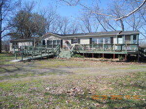2 living areas. 2 fireplaces. Bar 2/sink. Central h/a plus natural gas heater. Spacious kitchen and dining area. Pantry, storage rooms. Full length front deck with handicap ramp. 2 older barns, need work. Septic cleaned and new cleanouts added. Ductwork replaced under house a few years ago. Covered, enclosed brick patio. Has been leased for over 3 years.