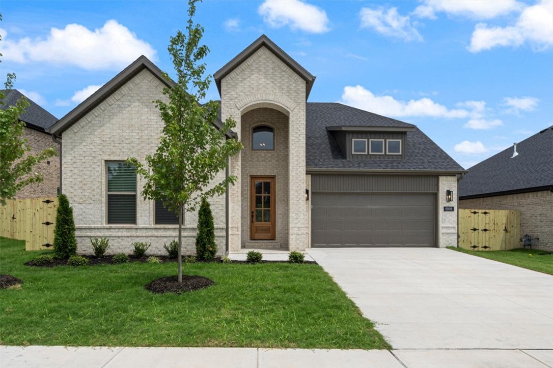 Builder offering up to $5,000 towards buyers closing costs, rate buydown or towards an appliance package like refrigerator, washer/dryer! Unmatched quality awaits in this new construction home with primary bedroom, bathroom, primary closet & second guest bedroom & full bathroom on main level. The second story features two additional guest bedrooms & full bathroom. Upgrades include quartz countertops, two-story open entry way, upgraded lighting fixtures, custom cabinets, black stainless steel appliances, gas fireplace, gas range, tiled walk in shower in primary bath & luxury vinyl plank floors throughout all bedrooms & common areas. Step outside to enjoy the backyard, with direct acess to the pond & walking trails! Enjoy standard inclusions such as insulated garages, full home gutters, privacy fence, & 2” blinds throughout. Community pool coming in Phase 2! Under 10 minutes to XNA Airport and under 20 minutes to Downtown Bentonville & New Walmart Campus! Ask your agent about the additional preferred lender credit.