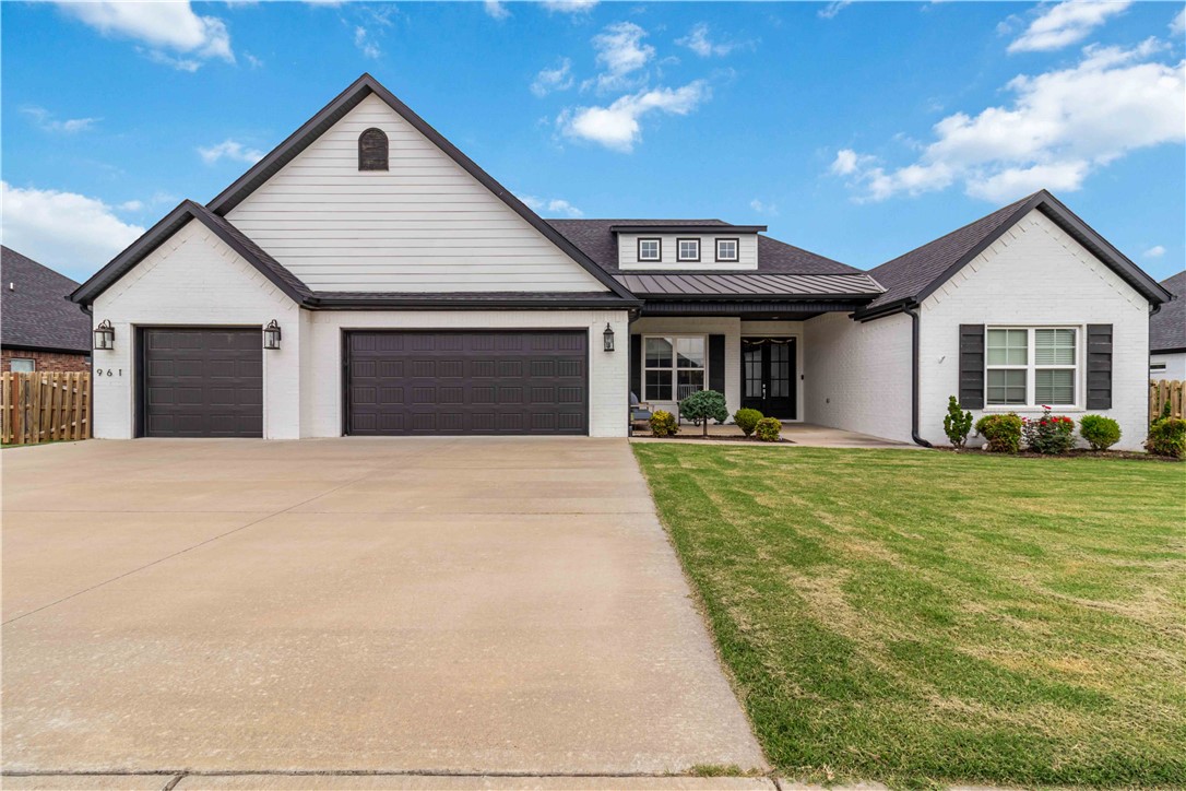 Contemporary style and everyday comfort come together in this beautifully maintained home on a professionally landscaped 0.4-acre lot. Designed for both entertaining and daily living, this exceptional residence features an open-concept floor plan with soaring ceilings, wood-look tile flooring, abundant natural light, and a cozy gas fireplace. The gourmet kitchen showcases an oversized island, custom cabinetry, stainless steel appliances, double ovens including a convection oven, and a spacious walk-in pantry. The luxurious primary suite offers dual vanities, a soaking tub, a large walk-in closet, and a spa-inspired walk-in shower with dual shower heads. An oversized 3-car garage provides ample room for vehicles, storage, and hobbies. Outside, enjoy a private backyard retreat with an extended covered patio, remote-controlled retractable screens, a relaxing hot tub, boat parking, and raised garden beds. Move-in ready, this home blends modern elegance, thoughtful  functionality, and exceptional outdoor living.