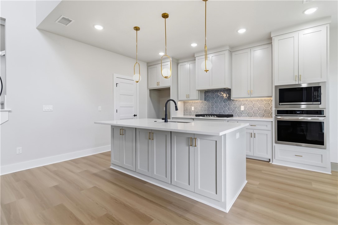 Experience the perfect blend of comfort and luxury in this stunning new construction corner-lot home featuring 4 bedrooms and 3.5 baths. Designed with thoughtful details throughout, the open floor plan is highlighted by soaring vaulted ceilings, custom cabinetry, elegant wrought-iron banister railings, and upscale finishes. The main level includes a spacious primary suite with a standalone soaking tub, tiled walk-in shower, dual vanities, and a walk-in closet. A dedicated office and half bath are also located on the main floor. The beautifully appointed kitchen showcases a designer backsplash and ample storage while opening seamlessly to the living and dining areas, creating an ideal space for entertaining. Upstairs, you'll find three additional bedrooms, including one with an en suite bathroom and a walk-in closet, making it an ideal guest suite. Additional features include an EV charger in the garage and a fenced backyard. This exceptional home combines modern style, functionality, and craftsmanship throughout.