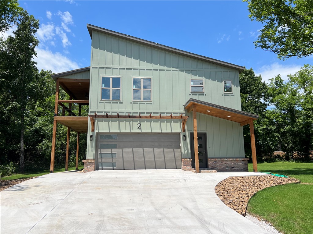 Experience modern living in this stunning contemporary home situated on a large, flat corner lot in the heart of Bella Vista! Designed with comfort, efficiency, and style in mind, this energy-efficient home features a dual fuel HVAC system, custom exterior finishes, and easy access to Hwy 49 for effortless commuting. Inside, you’ll love the open layout with 9’ ceilings and a vaulted living room ceiling that creates a bright, spacious feel. The kitchen is a showstopper with custom white oak cabinetry, high-end quartz countertops, designer trim work, and abundant built-ins throughout. The oversized 2-car garage is fully insulated, including the garage door, offering year-round comfort and functionality. Relax in the luxurious primary suite featuring a large custom walk-in shower and upscale finishes. Conveniently located near all Bella Vista amenities including trails, golf, lakes, parks, and recreation, this home combines custom craftsmanship with everyday convenience.