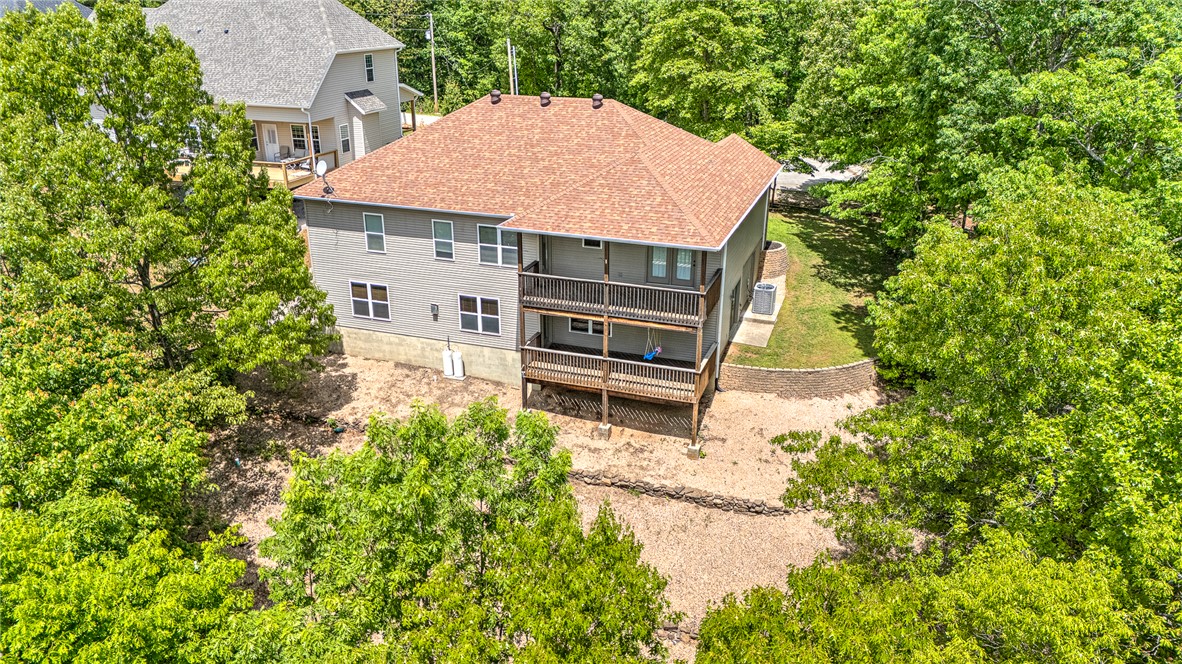 BELLA VISTA! DOUBLE LOTS! Welcome to 24 Kirby Dr., a stunning good sized three-bedroom (4th and 5th room space is office/extra rooms), two-story home nestled in the heart of Bella Vista on a quiet cul-de-sac. This exceptional property includes two lots, offering privacy and space rarely found at this price point. Outdoor enthusiasts will love the private direct access to the Back 40 Trail System, putting miles of world-class hiking and mountain biking right at your doorstep. Enjoy your mornings and evenings on the double-deck balconies overlooking the serene surroundings. Recent updates include a brand new HVAC system in 2025, fresh paint throughout, and stain-proof laminate wood flooring upstairs in 2024. The washer, dryer, and refrigerator all convey, making this a true move-in ready home. Whether you’re looking for room to grow, great sized rooms and closets, space to entertain, or a lifestyle centered around nature, this home checks every box. Don’t miss your chance to own a piece of Bella Vista’s finest.